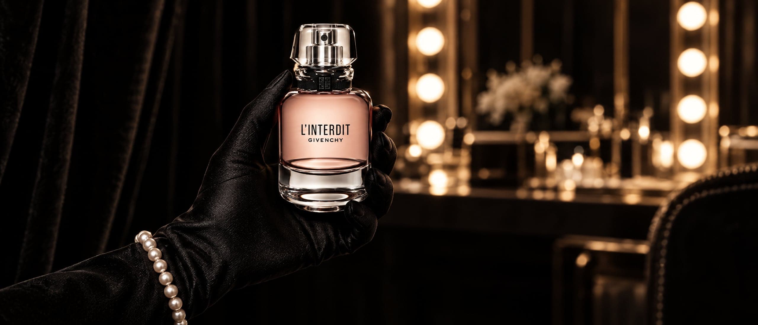 Givenchy L'Interdit held in a dark dressing room